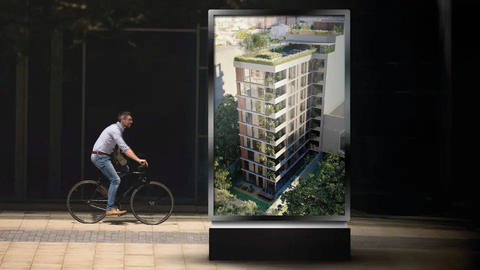 Persona en bicicleta frente a un cartel con el render de ANDO